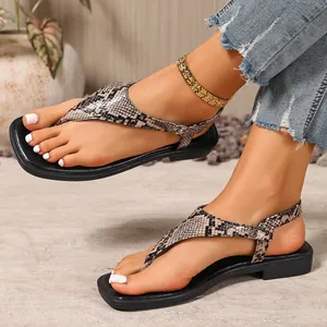 Side view of women's snakeskin pattern flat flip-flop sandals with buckle strap