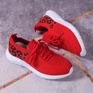 Detail view of red breathable knit sneakers for women with leopard print and flat soles