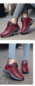 Detail of burgundy winter snow boots with rotary buckle and warm faux fur lining