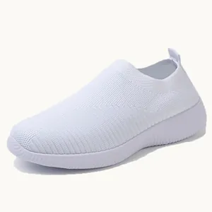 Lightweight women's white flyknit slip-on walking sneakers with flexible soft soles