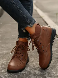 Detailed view of women's vintage brown lace-up ankle boots with thick soles