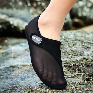Close-up of black breathable mesh water shoes for beach and swimming activities.