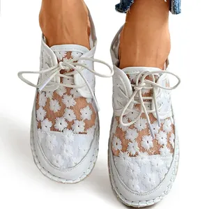 Close-up of white floral embroidered mesh lace-up casual shoes for women