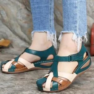 Detailed view of women's retro wedge sandals with colorful cross-straps and round toe