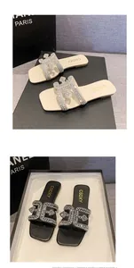 Detail view of square toe flat slippers with sparkling rhinestone buckle decorations