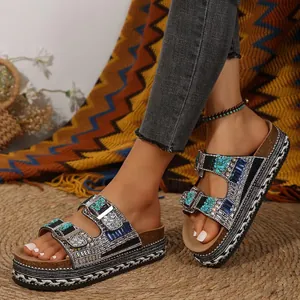 Close-up of bohemian platform sandals featuring rhinestones and turquoise accents.