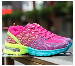 Detailed side view of vibrant pink and teal gradient women's mesh running shoes