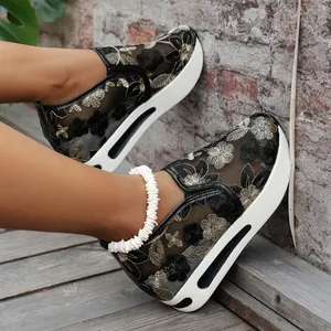 Close-up of the intricate floral embroidery and breathable mesh on these platform sneakers