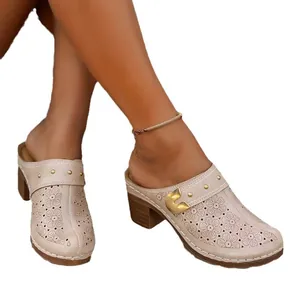 Elegant beige women's hollow-out floral clogs featuring chunky wedge heels and studs