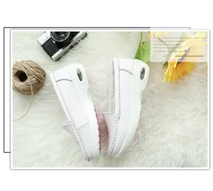Detailed close-up of white leather wedge loafers featuring visible heel air cushion unit