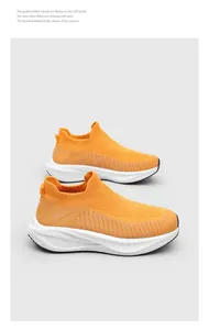 Detailed side view of vibrant orange fly-knit slip-on sock sneakers for summer running