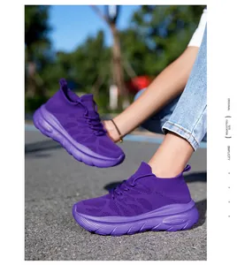Close-up of breathable purple knit sock sneakers worn outdoors featuring thick soles