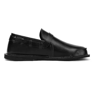 Side view of black vintage leather loafer with wide-toe design and textured finish