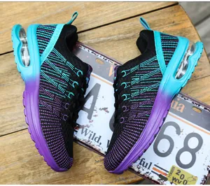 Detailed view of women's running shoes featuring a gradient purple EVA sole and knit upper