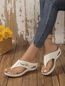 Stylish beige wedge thong sandals with hollow out design and stitching details.