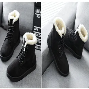Detailed view of women's black suede winter boots with thick white fleece lining