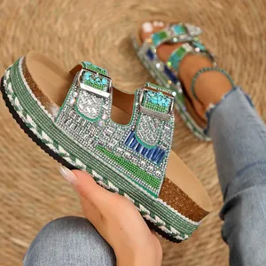 Close-up of rhinestone double buckle cork slippers with green braided rope detail.