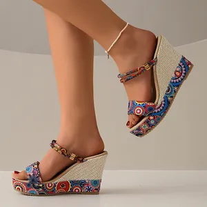 Close-up of bohemian colorful patterned wedge sandals featuring a woven straw heel.