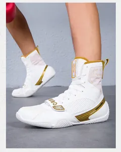 Close-up detail of professional high-top white and gold boxing shoes for wrestling training.