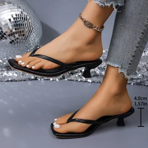 Close-up of stylish black thong kitten heels showing the 4cm heel height measurement