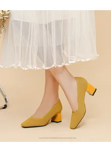 Close-up of elegant yellow chunky heel pumps with V-neck design and ribbed texture