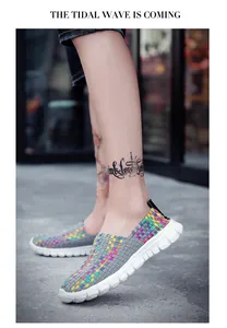 Detailed view of colorful woven elastic slip-on shoes worn by a model on the street.