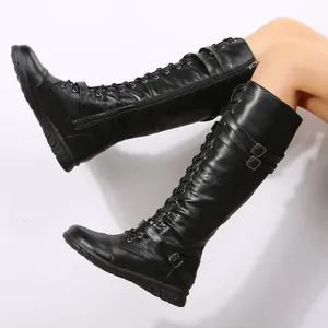 Knee-high black PU leather boots featuring lace-up front and stylish buckle straps