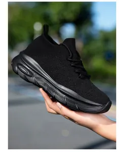 Detail view of stylish black breathable knit sock sneakers with thick platform soles