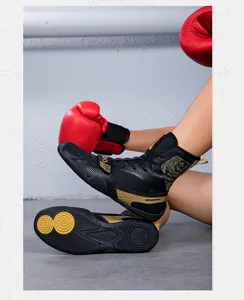 Close-up detail of professional high-top boxing shoes with golden accents and anti-slip sole
