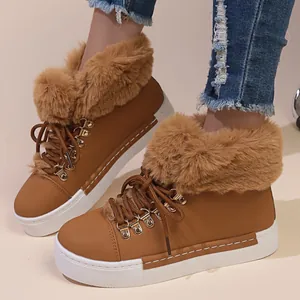 Close-up of brown faux leather snow boots with plush faux fur trim and platform sole.