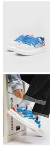 Detailed look at white retro sneakers with unique blue rope laces and streetwear styling