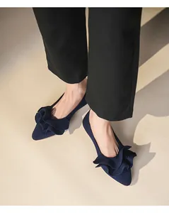 Detailansicht eleganter marineblauer Strickschuhe mit Rüschen und spitzer Kappe
