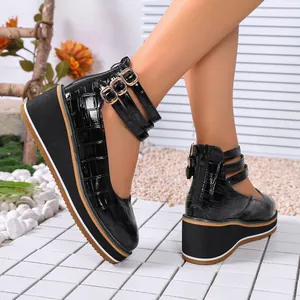 Élégantes chaussures compensées en cuir verni noir à motif croco et triples brides cheville.