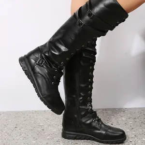 Detailed side view of black PU leather knee-high boots with buckles and lace-up