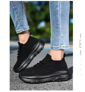 Detail of black knit sock sneakers showing breathable mesh texture and thick sole.
