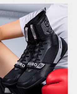 Detailed close-up of professional high-top boxing shoes with secure straps