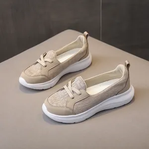 Stylish beige slip-on casual walking shoes for women with comfortable thick sole.