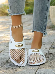 Detailed close-up of white mesh breathable flat mules with a decorative gold oval buckle