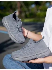 Detailed view of grey breathable knitted sock sneakers featuring thick textured soles