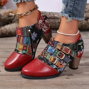 Macro detail of ethnic style women's ankle boots featuring chunky heels and red leather toes