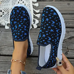 Detalle de zapatos slip-on de punto fly-knit para mujer con patrón de estrellas y lunas azules