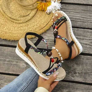 Detailed view of Bohemian wedge sandals with braided straps and bead accents.