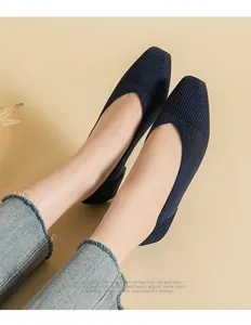 Close-up of breathable navy blue knit ballet flats with elegant square toe design.
