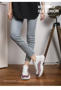 Close-up of white breathable knit chunky sneakers with rainbow details worn by model
