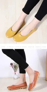 Detailed view of women's cowhide leather loafers in yellow and brown with soft rubber soles