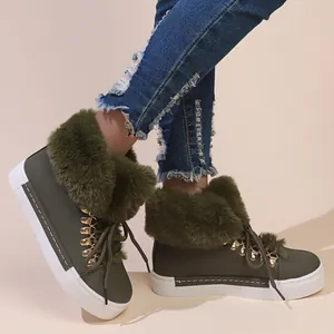 Detail view of olive green faux fur snow boots for women with lace-up design