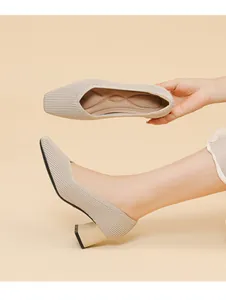 Detailed view of beige knitted block heel pumps with supportive cushioned insole.