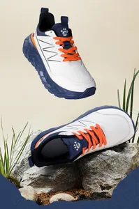 Detail shot of men's wide-toe sports shoes with thick blue soles and orange laces.