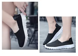 Detailed view of breathable black woven elastic slip-on sneakers on feet with white sole