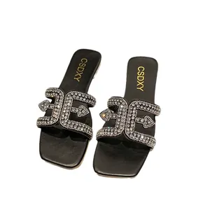 Elegant black square-toe flat slippers for women featuring a sparkling rhinestone strap design